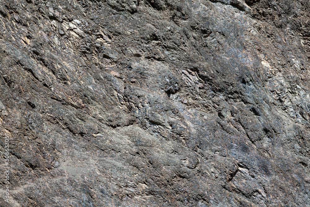 Background with a rough texture of gray and brown color of stone and rock on the mountain. Decor and desigh of interior. Background with a rough texture of gray and brown color of stone and rock on the mountain. Decor and desigh of interior.