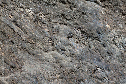 Background with a rough texture of gray and brown color of stone and rock on the mountain. Decor and desigh of interior.