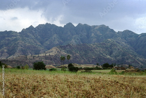 Typical village Akkrani taluka. A typical tribal village in the Narmada valley in the Akkrani taluka of Dhule district with part of the Satpura range in the background. photo