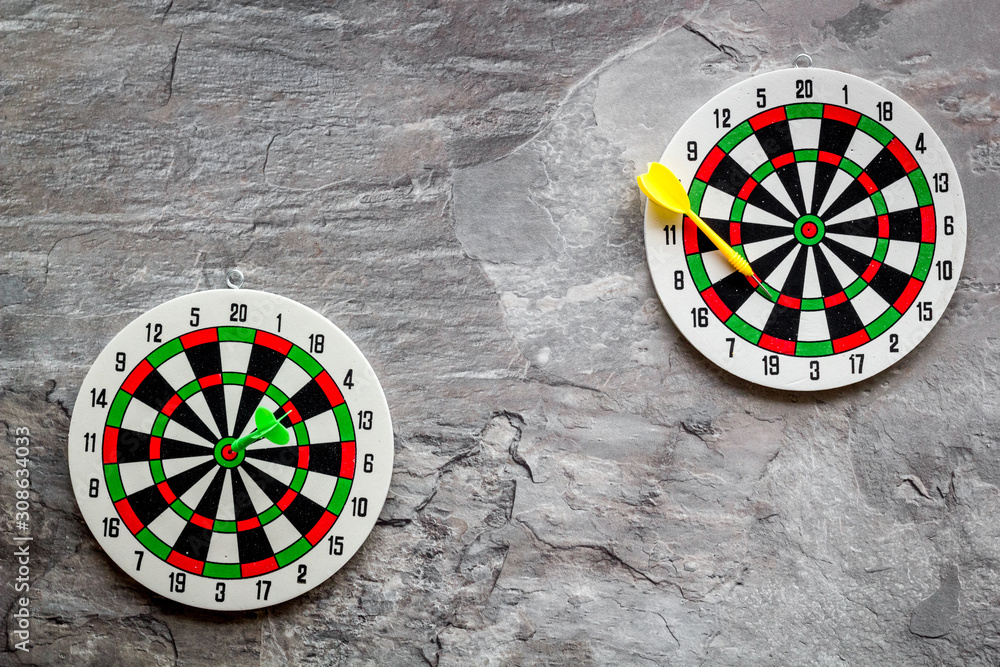 Darts game - simple sport for lesure time. Dartboard and arrows or dart on  grey background top view copy space Stock Photo | Adobe Stock