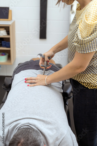 Man having chiropractic back adjustment. Physioterapy, osteopathy, alternative medicine pain relief rehabilitation photo