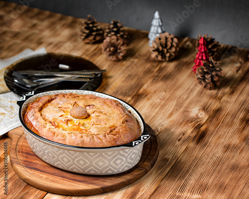 Freshly baked pie with duck meat, potatoes and onions. photo