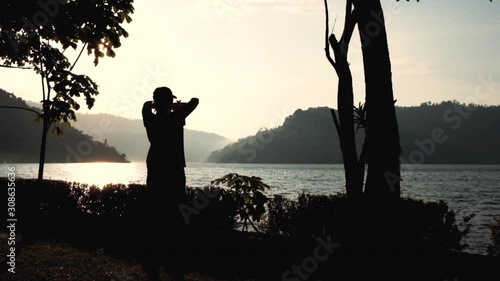  Silhouette of woman stretching exercise at dam. Healthy Lifestyle.