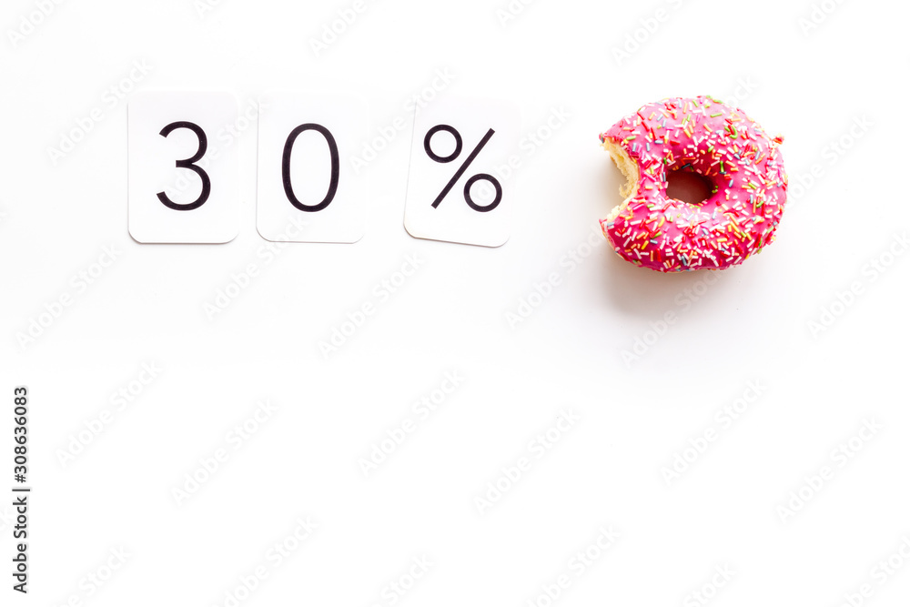 30% off discount - sale concept with bitten donut - on white background top-down copy space 30% off discount - sale concept with bitten donut - on white background top-down copy space