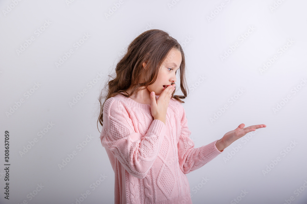 a little brunette girl shows different emotions joy, sadness, surprise isolated on white background a little brunette girl shows different emotions joy, sadness, surprise isolated on white background