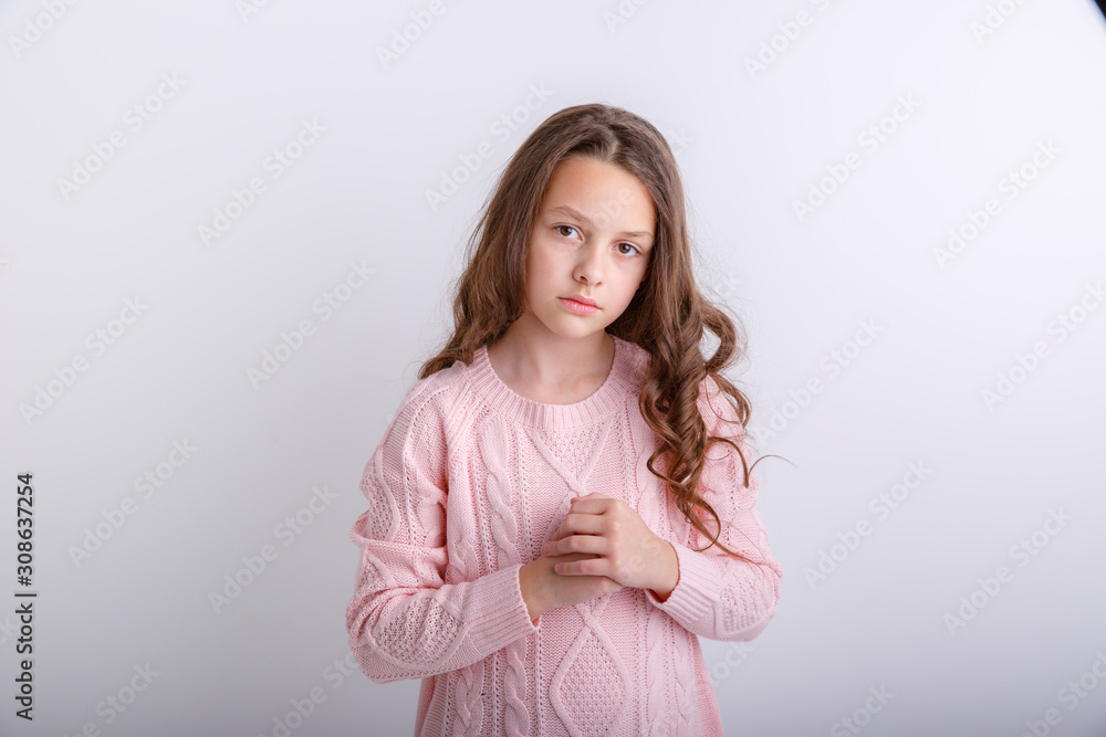 a little brunette girl shows different emotions joy, sadness, surprise isolated on white background a little brunette girl shows different emotions joy, sadness, surprise isolated on white background