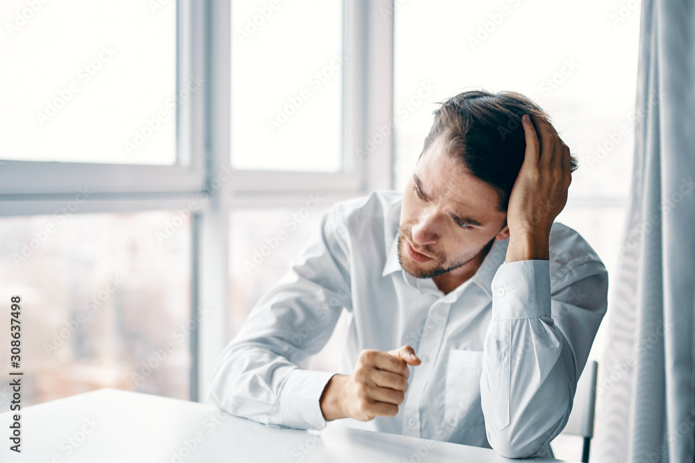 businessman sitting at his desk in office businessman sitting at his desk in office