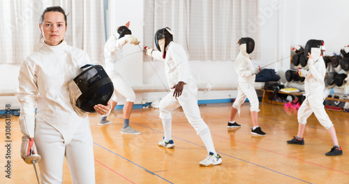 Female fencer standing in gym