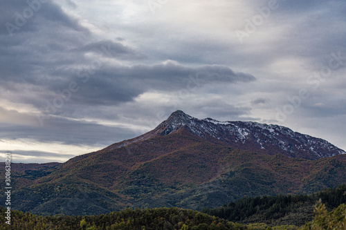 Snowy cloudscape sky with mountain snowy peak in Catalonia mountains landscape