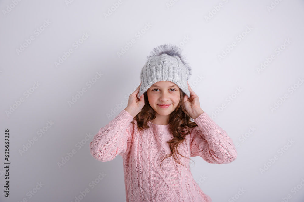 little girl in knitted winter hat on white background little girl in knitted winter hat on white background