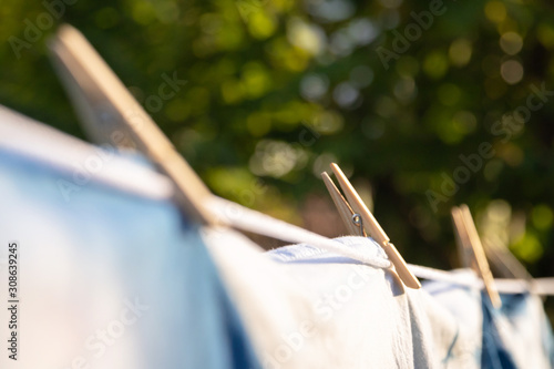 Wooden clothespins with clothes of natural indigo dyeing extracted dry in the sun.