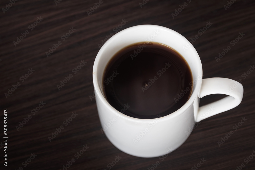 Cup of black coffee on wooden table background with copy space. Cup of black coffee on wooden table background with copy space.