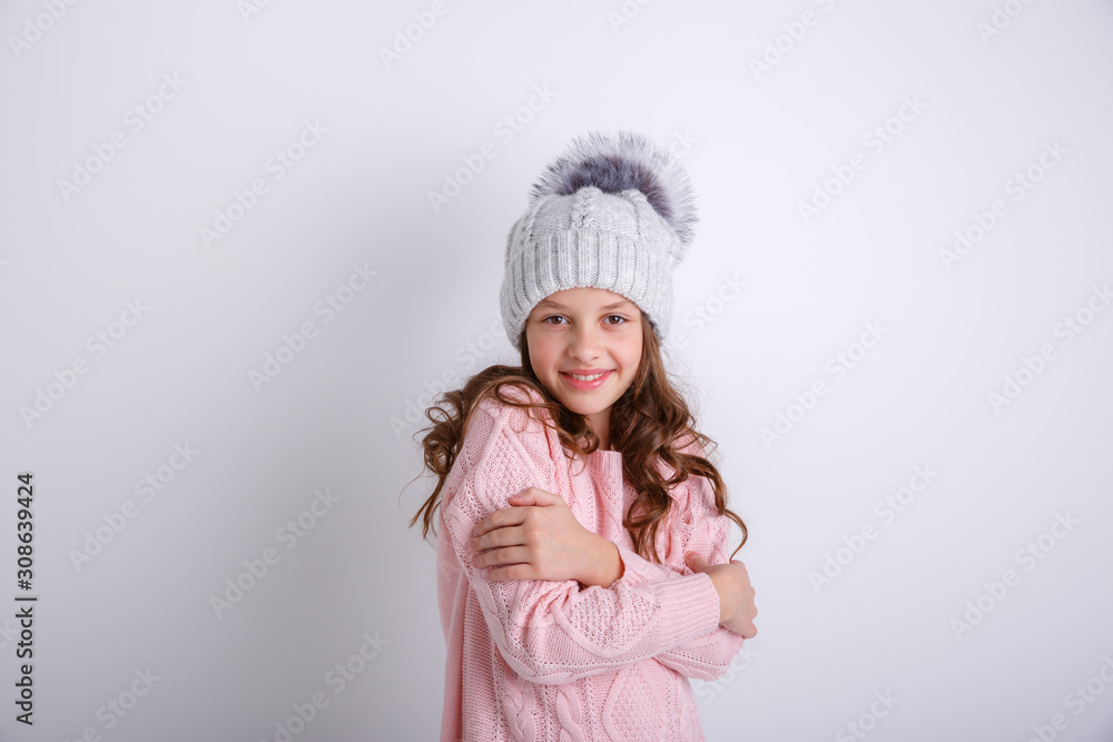 little girl in knitted winter hat on white background little girl in knitted winter hat on white background