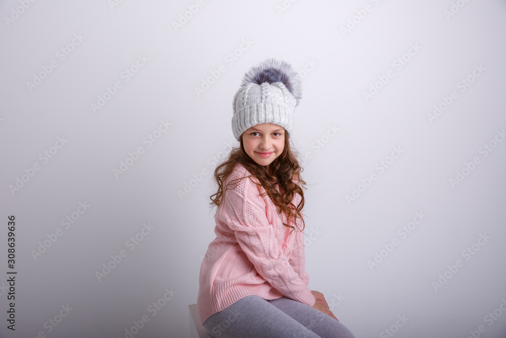 little girl in knitted winter hat on white background little girl in knitted winter hat on white background