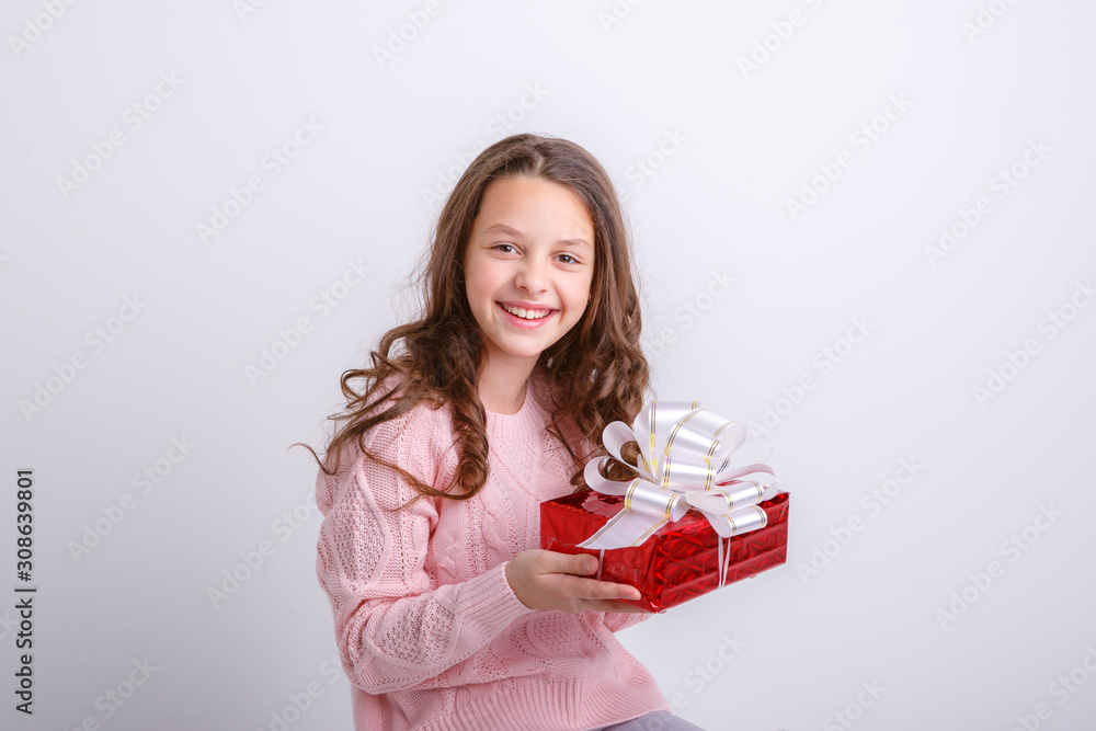 little girl smiling looking at gift on isolated white background little girl smiling looking at gift on isolated white background