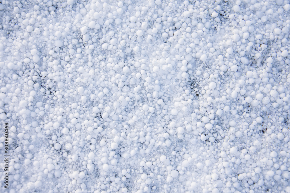 Background texture of snow cover in the form of round grains.