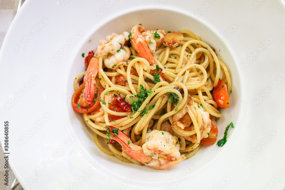 Spaghetti shrimp scampi with garlic,olive oil and chili on white plate. Top view 