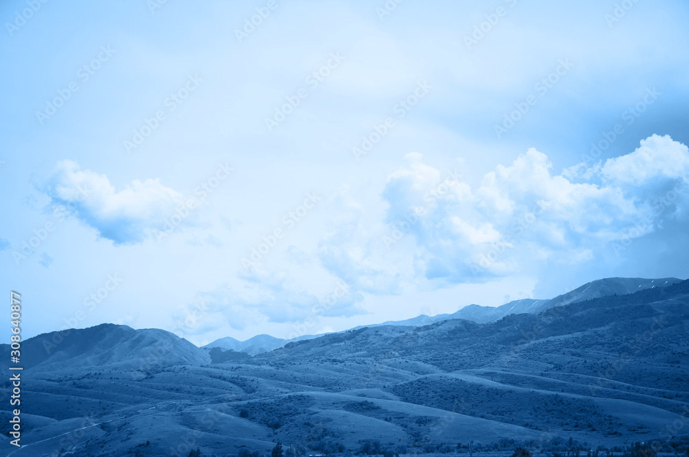 Green hills, mountains valley and blue sky.