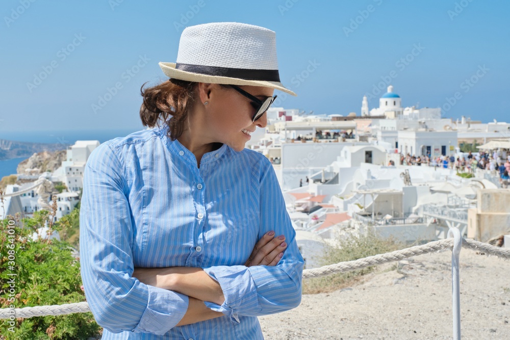 Luxury cruise vacation of mature woman, visiting Santorini island