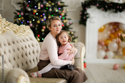 Child with disabilities with mom, Christmas tree © natalialeb