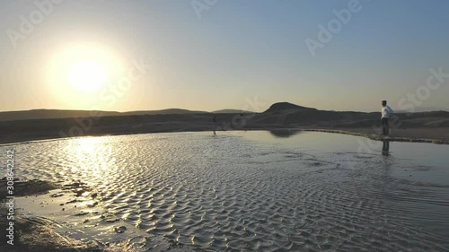 Two Mean Watch The Mud Volcanos In Baku, Azerbaijan. photo