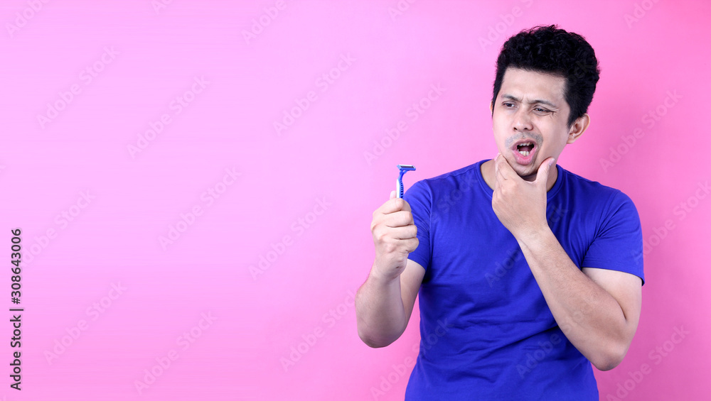 Portrait Handsome Asia man with a shaving on pink background in studio With copy space. Portrait Handsome Asia man with a shaving on pink background in studio With copy space.