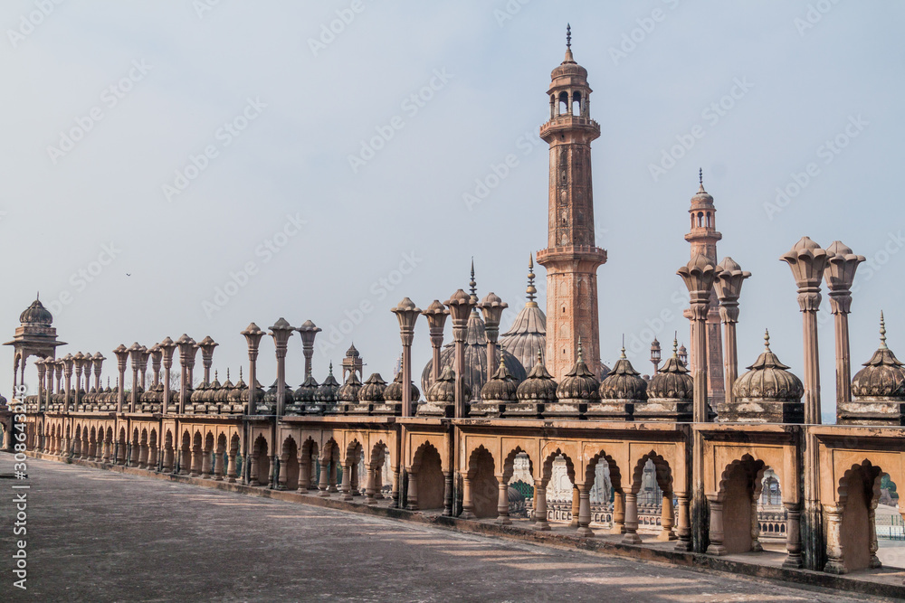 Decorative railing of  Bara Imambara in Lucknow, Uttar Pradesh state, India. Asfi mosque in the background.