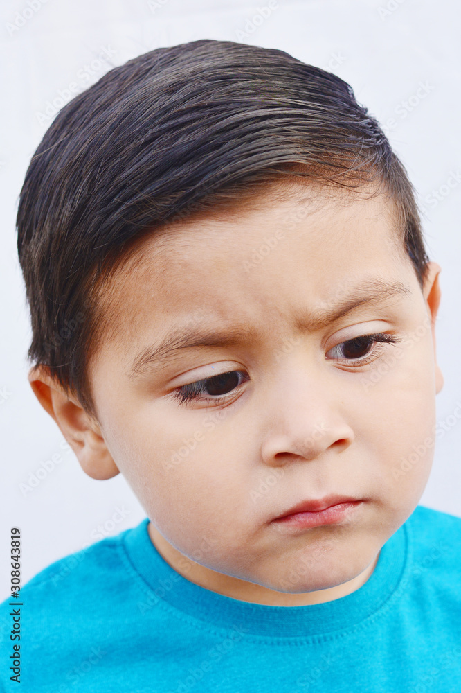 Unhappy little latin boy. White background. Unhappy little latin boy. White background.
