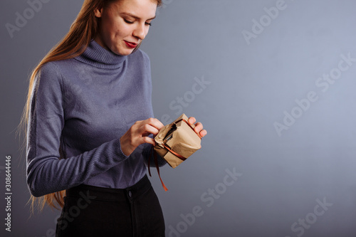 Very sexy and attractive lady opening christmas gift box. Girl celebrates holiday. Taking present from someone. surprise.