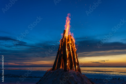 The big fire burns against the background of the night sky, close up