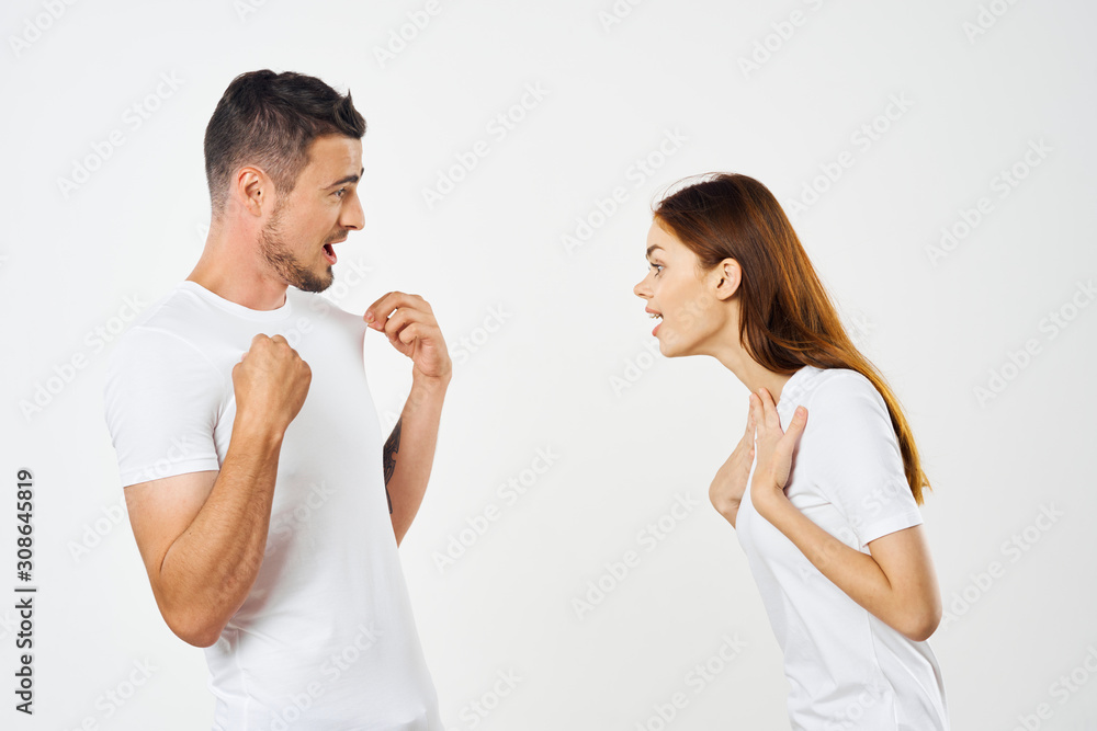 young couple in t-shirts chatting young couple in t-shirts chatting