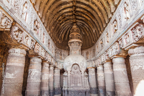 AJANTA, INDIA - FEBRUARY 6, 2017: Interior of the Buddhist chaitya (prayer hall), cave 19, carved into a cliff in Ajanta, Maharasthra state, India