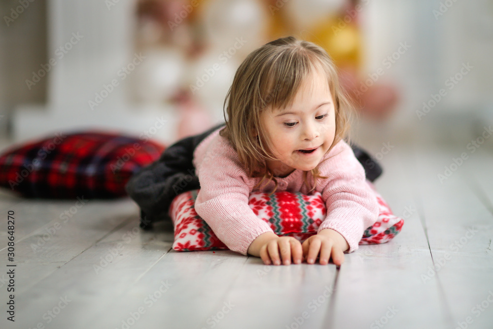 Caucasian child with disabilities lies on floor Caucasian child with disabilities lies on floor