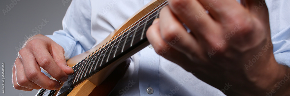 Male arms playing classic shape electric guitar Male arms playing classic shape electric guitar