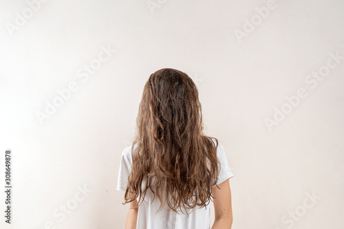 No face portrait of young woman with brown messy hair. Sleepy concept