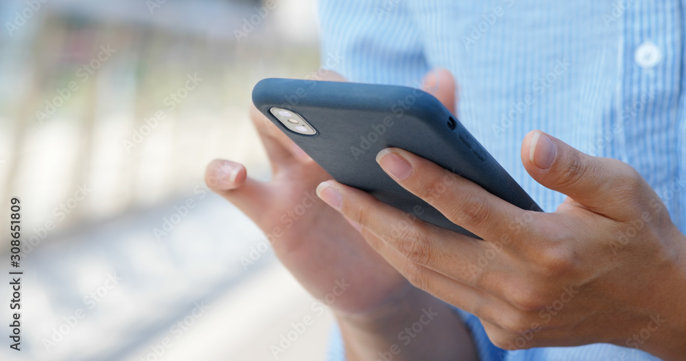 Woman touch on mobile phone in city