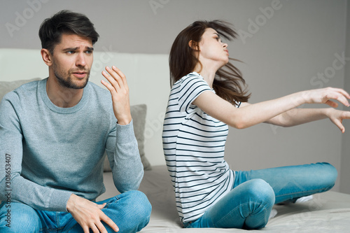 young couple sitting on sofa at home