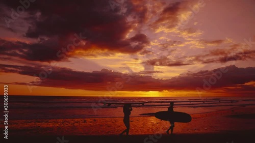 Beautiful 4k UHD seamless video loop / cinemagraph sunset on a wide and remote sandy Pacific beach at Santa Teresa, Costa Rica. The clouds are colorizing the entire sky and the waves.