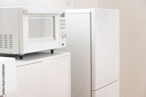 Minimalist mini kitchen with microwave and fridge, bright interior　白い冷蔵庫と電子レンジ　ミニキッチン