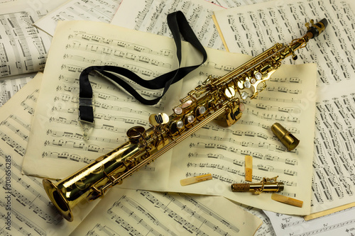 Photos Soprano saxophone lying on a background of music