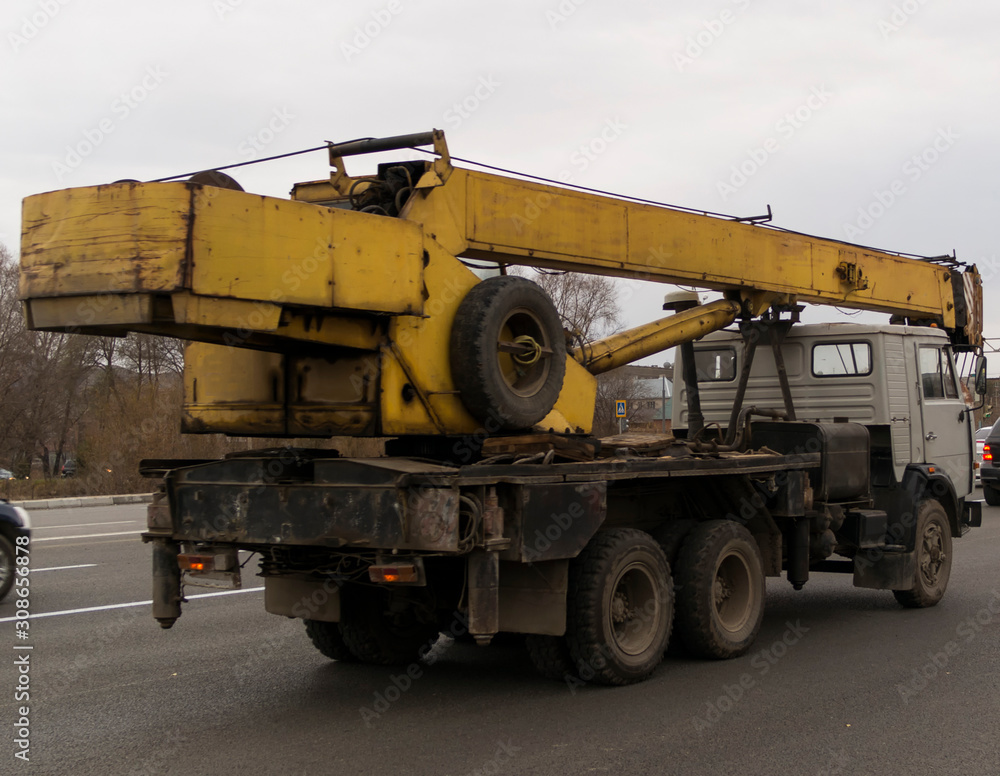 Mobile construction hydraulic crane truck on the road. Mobile construction hydraulic crane truck on the road.