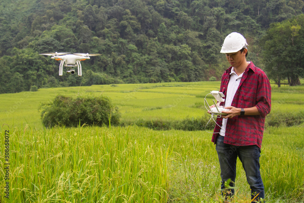 A agricultural engineering with a remote control in his hands. Flight control of the drone. A agricultural engineering with a remote control in his hands. Flight control of the drone.