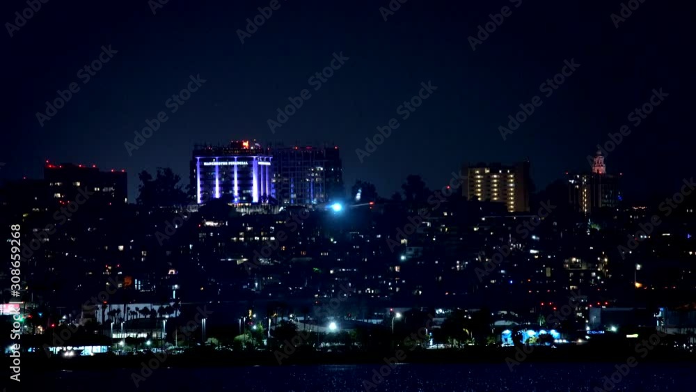 Airplane flying over the San Diego skyline at night Airplane flying over the San Diego skyline at night