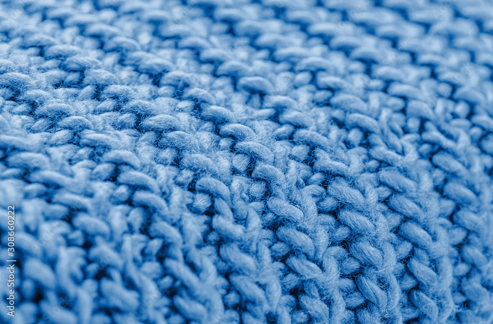 Blue knitted fabric closeup. Knitted wool background. Handmade. Blue knitted fabric closeup. Knitted wool background. Handmade.