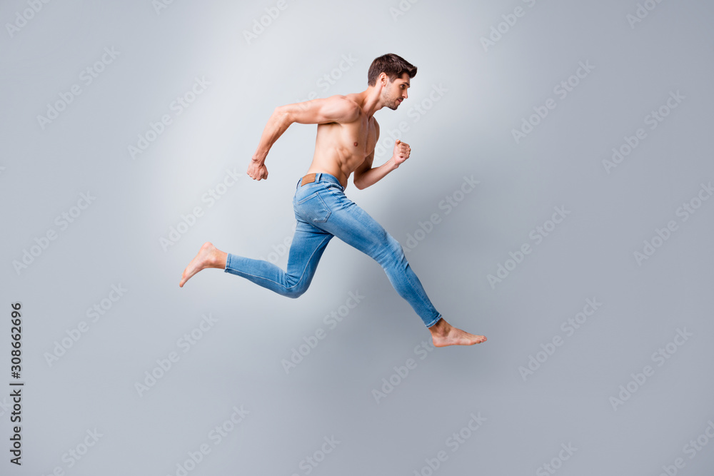 Full size profile photo of macho man guy jumping high running marathon topless torso metrosexual hot body competitive mood wear only jeans isolated grey background