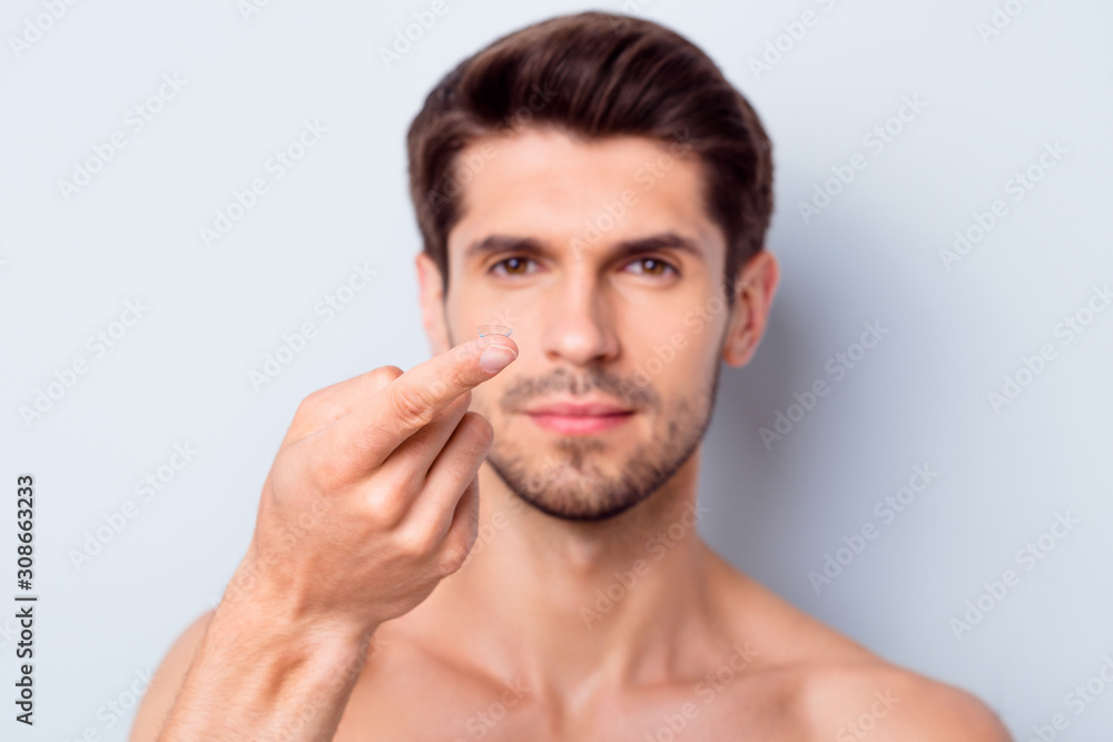 Close-up portrait of his he nice attractive confident bearded brown-haired guy holding on finger invisible eye lens focus isolated over light white gray color pastel background Close-up portrait of his he nice attractive confident bearded brown-haired guy holding on finger invisible eye lens focus isolated over light white gray color pastel background