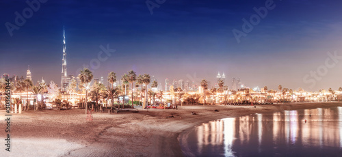 Photography Landscape with deserted night beach and illuminated skyscrapers in the backgroun