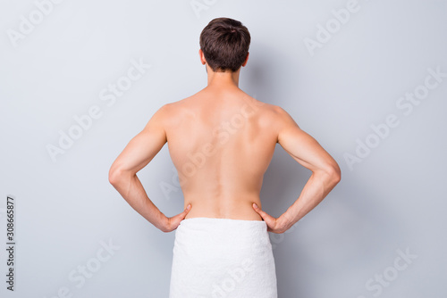 Back rear side view photo of handsome guy stand after man spa salon skincare therapy treatment have white towel isolated over grey color background