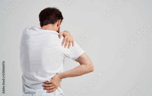 Obraz na plátně man with pain in his neck isolated on white