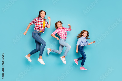Full length body size photo of rejoicing cheerful glad white pin-up family running after each other wearing jeans denim while isolated with blue background